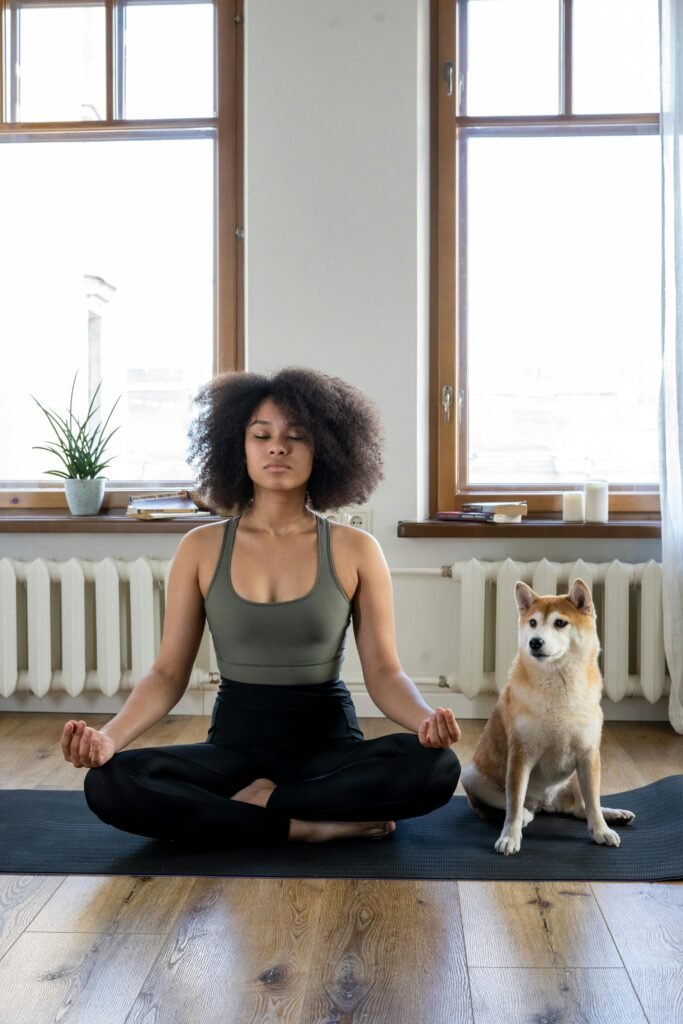 Woman Meditating Beside her Dog