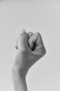 A powerful black and white image of a clenched fist representing strength and determination.